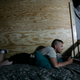 A U.S. soldier playing a video game in his barracks in Iraq (2009)
